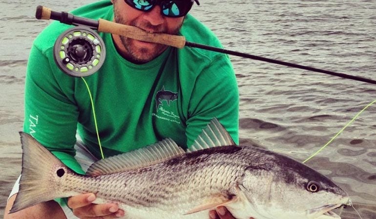 Anna Maria Island fishing charter client with redfish on the fly rod.